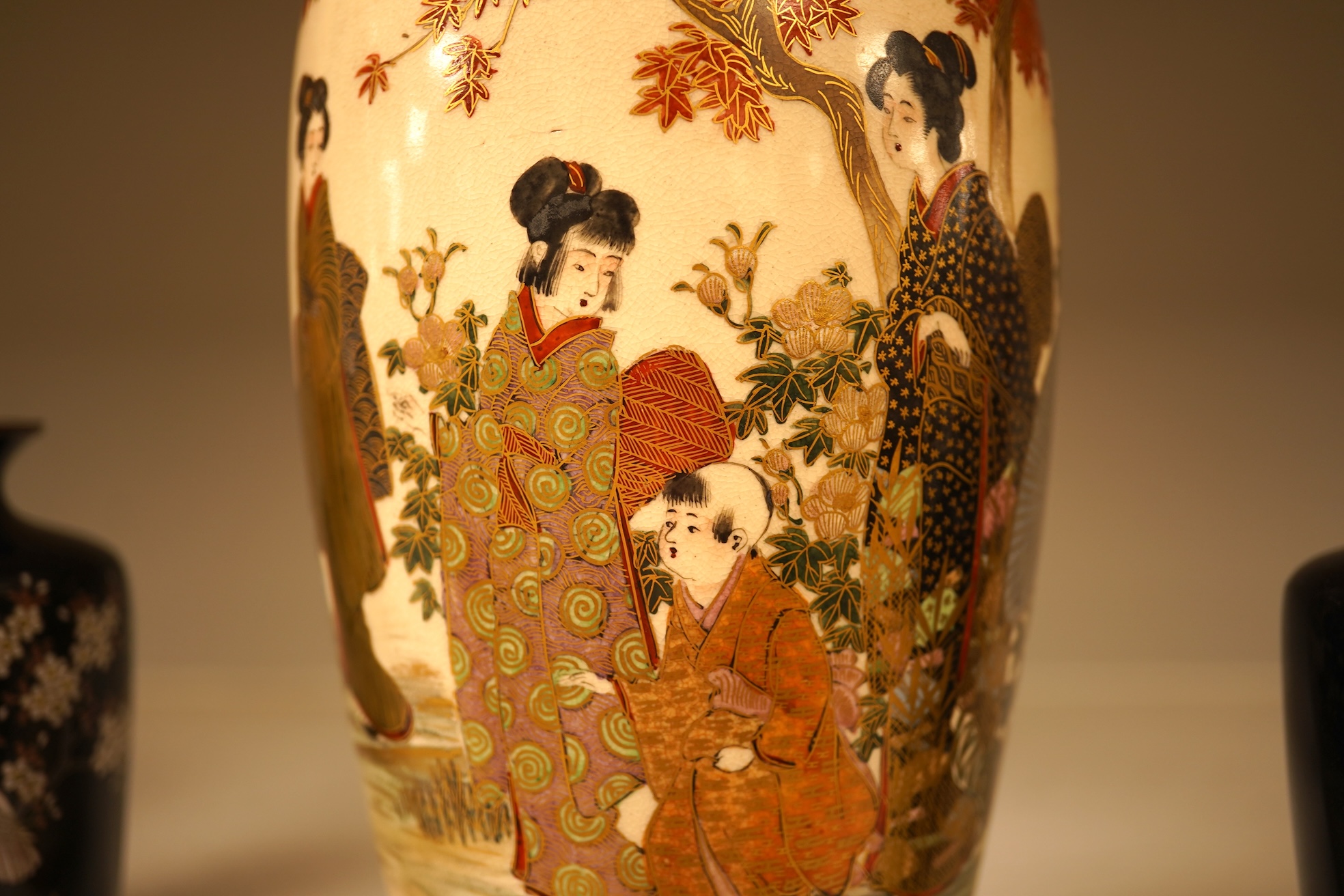 A Japanese figural satsuma vase and a pair of small black cloisonné enamel vases, Satsuma 21.5cm high